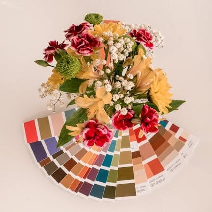 Aerial view of a colorful flower bouquet overlaid with a variety of color swatches.